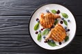 Grilled pork steak with blueberry sauce and spinach close-up. Ho Royalty Free Stock Photo