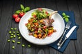 grilled pork steak with a bone in a sweet honey glaze and vegetable stew with green beans Royalty Free Stock Photo