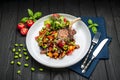 grilled pork steak with a bone in a sweet honey glaze and vegetable stew with green beans Royalty Free Stock Photo