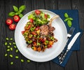 grilled pork steak with a bone in a sweet honey glaze and vegetable stew with green beans Royalty Free Stock Photo