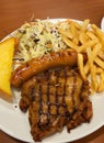 grilled pork steak with french fries and potato wedges Royalty Free Stock Photo