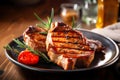 Grilled pork steak on a plate close-up. Beef fillet with rosemary sprig. Rare roast beef meal on a dark wooden rustic table. Image Royalty Free Stock Photo