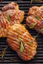 Grilled pork steak, pork neck with the addition of herbs and spices on the grill plate, top view Royalty Free Stock Photo