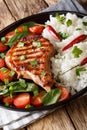 Grilled pork steak with rice garnish and fresh vegetable salad close-up. vertical Royalty Free Stock Photo