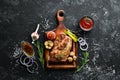 Grilled pork steak with spices on black stone background. Royalty Free Stock Photo