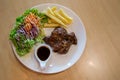 Grilled pork steak and vegetables . plate of grilled pork with french fries and salad on Table. juicy grilled pork chop neck cut Royalty Free Stock Photo