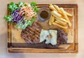 Grilled pork steak and vegetables . plate of grilled pork with french fries and salad on Table. Royalty Free Stock Photo