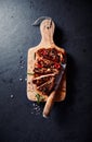 Grilled pork steaks with chili peppers and spices Royalty Free Stock Photo