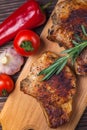 Grilled pork steaks and vegetables on a rustic wooden table. Grilled meat on the bone with spices Royalty Free Stock Photo