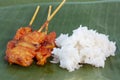 Grilled pork with sticky rice on banana leaf background. Royalty Free Stock Photo