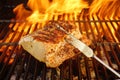 Grilled Pork Striploin, Fork and BBQ Flames Royalty Free Stock Photo