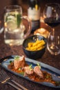 Grilled pork tenderloin with mushroom sauce served on plate with glass of wine and dumplings, modern seasonal gastronomy Royalty Free Stock Photo