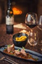 Grilled pork tenderloin with mushroom sauce served on plate with glass of wine and dumplings, modern seasonal gastronomy Royalty Free Stock Photo