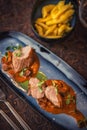 Grilled pork tenderloin with mushroom sauce served on plate with glass of wine and dumplings, modern seasonal gastronomy Royalty Free Stock Photo