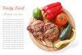 Grilled pork and vegetables on a cutting board isolated top view Royalty Free Stock Photo