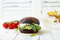 Grilled portobello bun mushroom burger. Vegan, gluten free, grain free, healthy veggies hamburger with guacamole, fresh vegetables