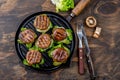 Grilled portobello bun mushroom burgers on cast iron grill pan ob wooden background, top view