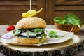 Grilled portobello mushroom burger. Healthy veggies hamburger with onions, arugula, cheese, spicy pickled hot peppers Royalty Free Stock Photo