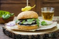 Grilled portobello mushroom burger. Healthy veggies hamburger with onions, arugula, cheese, spicy pickled hot peppers Royalty Free Stock Photo