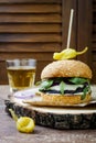 Grilled portobello mushroom burger. Healthy veggies hamburger with onions, arugula, cheese, spicy pickled hot peppers Royalty Free Stock Photo