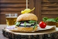 Grilled portobello mushroom burger. Healthy veggies hamburger with onions, arugula, cheese, spicy pickled hot peppers Royalty Free Stock Photo