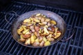 Grilled potatos with onionin on barbecue