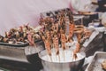 Grilled prawn and squid skewers at street food market, selective focus