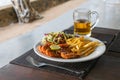 Grilled prawns served with french fries and vegetable salad. Snacks for beer Royalty Free Stock Photo