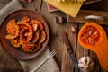 Grilled pumpking slices on wooden table. Healthy vegan food. Flat lay