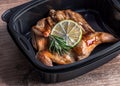 Grilled quail in a plastic container