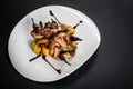 Grilled quail meat with vegetables on black background Royalty Free Stock Photo