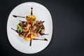 Grilled quail meat with vegetables on black background Royalty Free Stock Photo