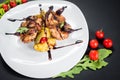 Grilled quail meat with vegetables on black background Royalty Free Stock Photo