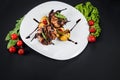 Grilled quail meat with vegetables on black background Royalty Free Stock Photo