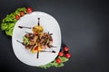 Grilled quail meat with vegetables on black background Royalty Free Stock Photo