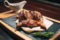 Grilled quails on wooden plate in a restaurant Royalty Free Stock Photo