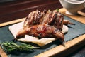 Grilled quails on the wooden plate on the table Royalty Free Stock Photo