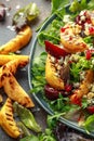 Grilled quince salad with baked and fresh grated beetroot, blue cheese, walnuts on rustic table