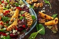 Grilled quince salad with baked and fresh grated beetroot, blue cheese, walnuts on rustic table