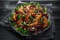 Grilled quince salad with baked and fresh grated beetroot, blue cheese, walnuts on wooden rustic dark table