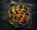 Grilled quince salad with baked and fresh grated beetroot, blue cheese, walnuts on wooden rustic dark table