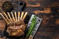 Grilled rack ribs of lamb meat chops. Dark wooden background. Top view. Copy space Royalty Free Stock Photo