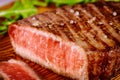 Grilled rare angus beef steak on wooden board Royalty Free Stock Photo