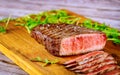 Grilled rare angus beef steak on wooden board Royalty Free Stock Photo