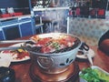 Grilled raw sliced beef and pork on the hot stainless steel stove with smoke Royalty Free Stock Photo