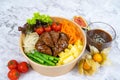 GRILLED RIB-EYE STEAK BLACK PEPPER with salad, tomato and sauce served in a bowl isolated on grey background side view healthy Royalty Free Stock Photo