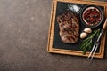 Grilled rib eye steak, spices and vintage meat fork on serving b Royalty Free Stock Photo