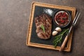 Grilled rib eye steak, spices and vintage meat fork on serving b Royalty Free Stock Photo