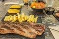 Grilled rib steak served in a Latin restaurant with a glass of red wine Royalty Free Stock Photo