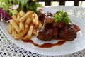 Grilled rib steak serving with french fried and lettuce salad